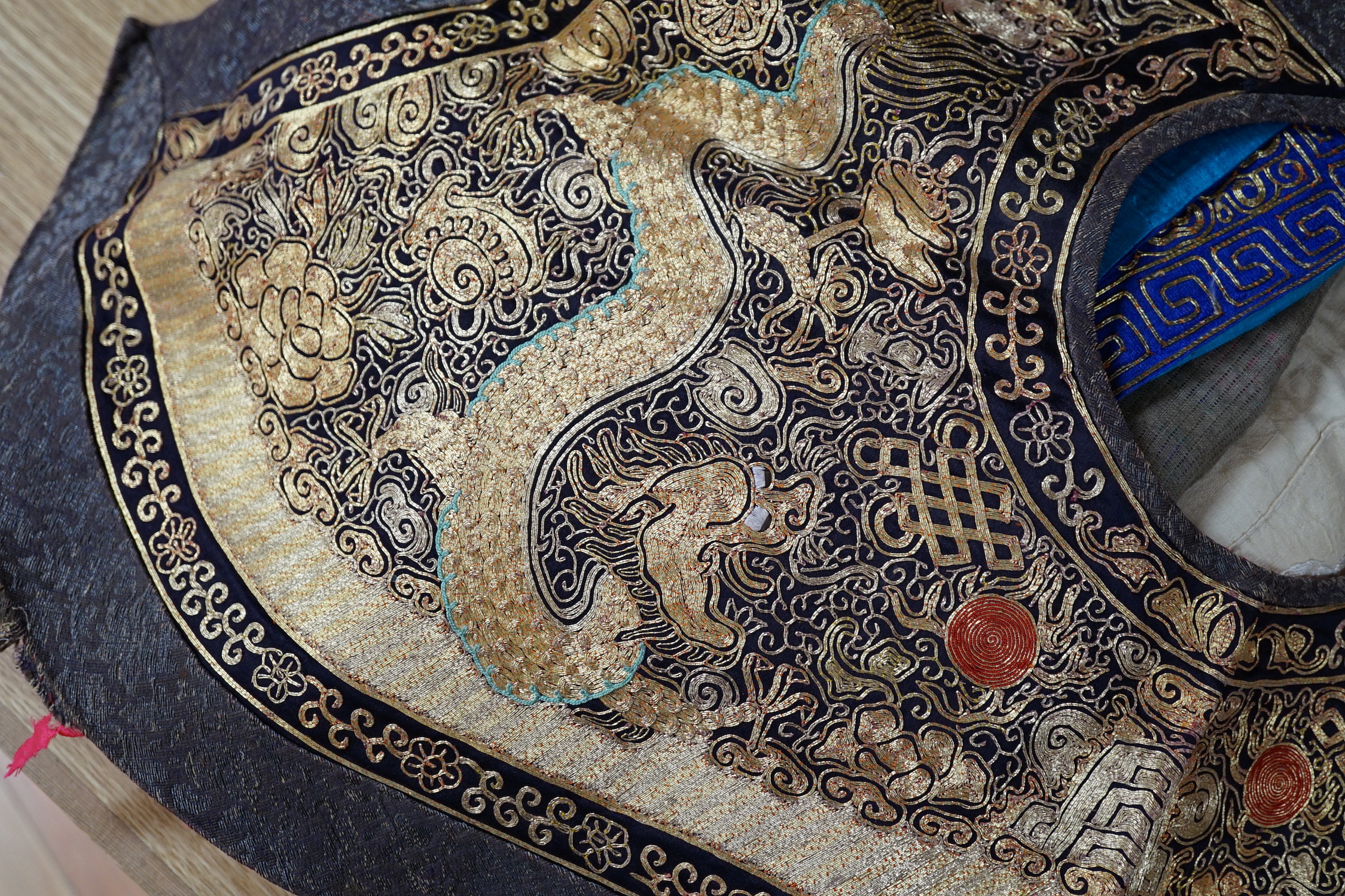 Two mid 20th century Chinese embroidered Rank Badges, a large gold thread dragon embroidered collar, three Chinese embroidered panels and a Japanese 1930’s Shantung silk dragon embroidered Kimono dressing gown